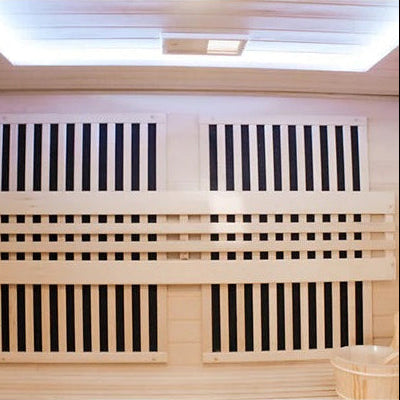 Wooden sauna with benches and a bucket of wooden sticks.