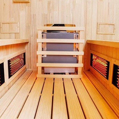 Wooden sauna interior with benches and heat lamps.