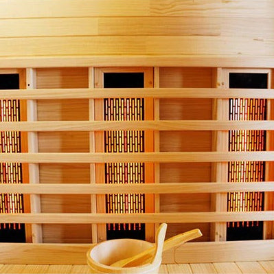 Infrared sauna with wooden interior and a ladle on a white background